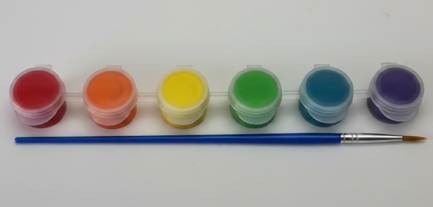 Set of paints with a brush on a white background