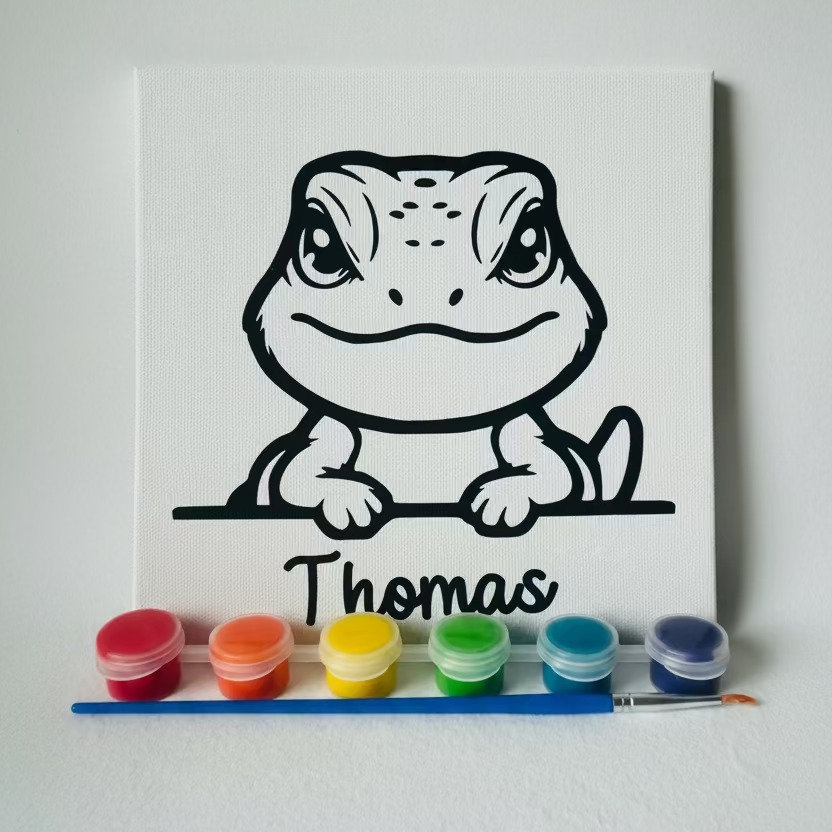 Canvas with a lizard drawing and 'Thomas' text, placed on a colorful zigzag patterned surface.